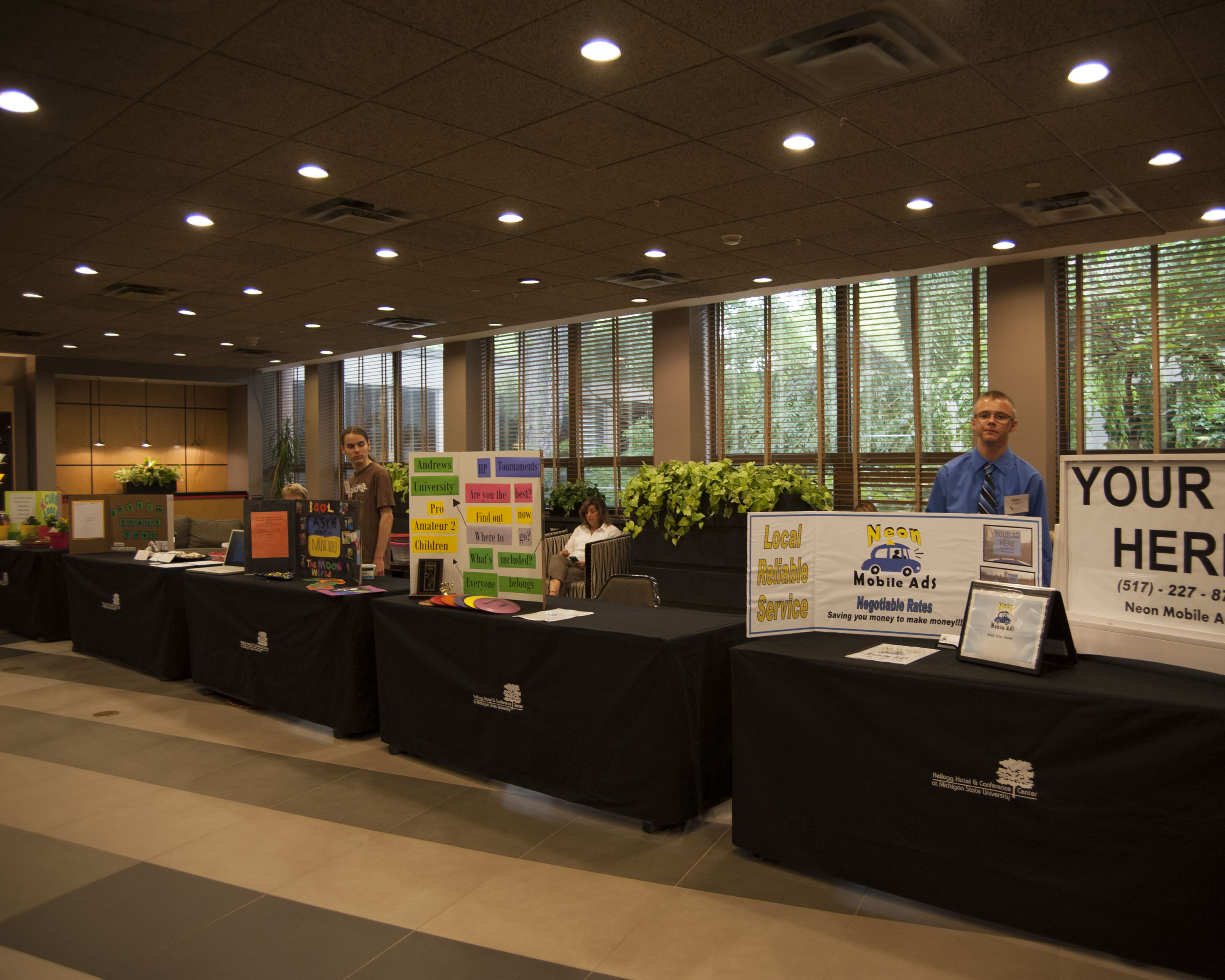 Photo of young entrepreneurs promoting their businesses at the Innovate Michigan! Summit on September 4, 2014.