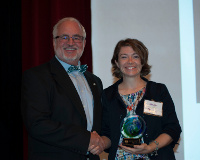 Melissa Horste accepting a plaque on behalf of Photo of Senator Levin from Rex LaMore.