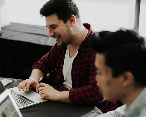 Two people working on computers.