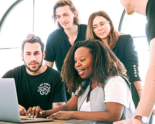 Four people looking at computer